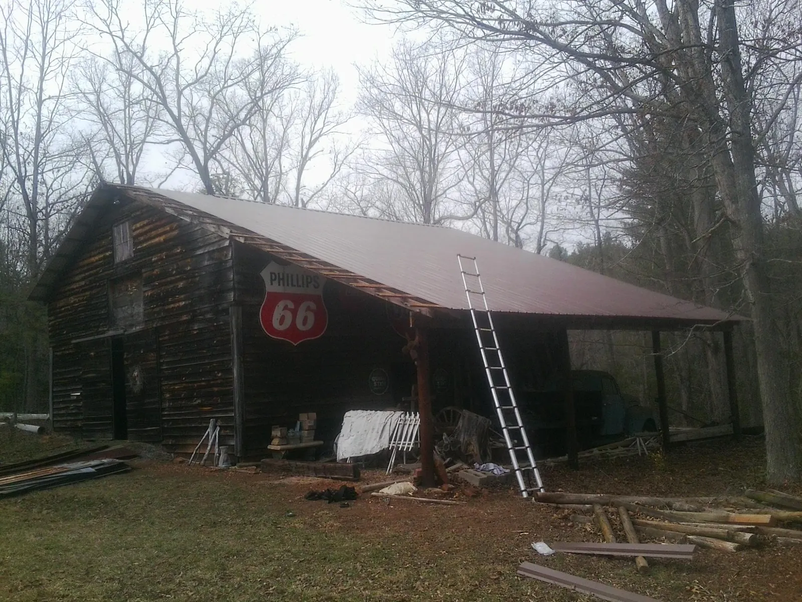 New metal roof on an open sided timber barn with a vintage sign in Reagan