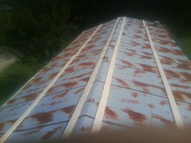Rusted metal roof panels with new wood purlins before replacement — Storm Damage Roof Repair in Reagan by Roofing Brothers
